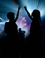 Image showing People, dancing and crowd or concert silhouette for live music performance or festival, rock or friends. Audience, dj and stage lights for celebration rave or band sound as partying, weekend or night