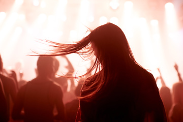 Image showing Person, dancing and crowd or concert silhouette for live music performance or festival, rock or friends. Audience, club and red lights for celebration rave or band sound as partying, weekend or night