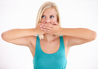 Image showing Woman, thinking and cover mouth with secret about announcement in studio on white background. Wow, surprise and girl with hands on face to hush gossip or omg expression for crazy news, story or idea