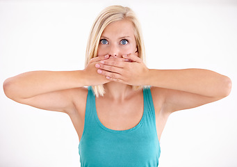 Image showing Silence, portrait and woman with hands on mouth, scared and confused with confidential secret in studio. Quiet, privacy and shocked face of girl with gossip, anxiety and surprise on white background.