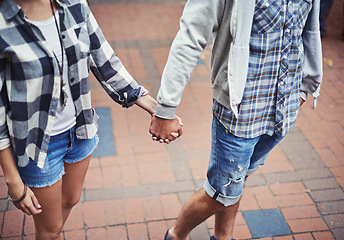 Image showing Love, walking and couple holding hands on relax journey, morning trip or weekend tour for outdoor adventure. Fashion, casual clothes and romantic people commute on street, road or sidewalk floor