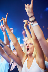 Image showing Woman, crowd and cheering at concert for live performance at music festival for entertainment, brand or listening. Female people, hands up and celebrate for dj musician or rave weekend, party or fans