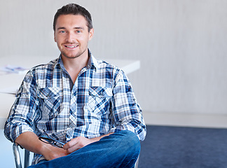 Image showing Chair, entrepreneur or portrait of happy man with smile, small business or confidence in office. Sitting, male designer or employee with pride at startup job, career or company alone by mockup space