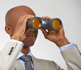 Image showing Businessman, searching and career opportunity with binoculars in studio for job, professional or white background. Male person, smile and employment future growth or mockup space, search or corporate