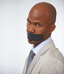 Image showing Businessman, portrait and tape on mouth silence or corporate censored for secret, blackmail or quiet. Black person, face and journalist in company career trouble or white background, studio or mockup