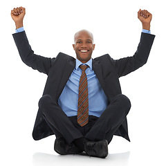 Image showing Happy businessman, portrait and fist pump in celebration for bonus promotion on a white studio background. Excited black man or employee smile sitting on floor for winning, achievement or promo deal