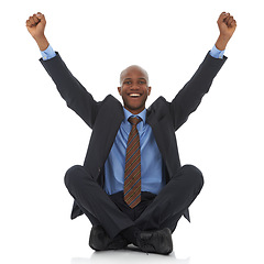 Image showing Happy businessman, portrait and fist pump for promotion, bonus or celebration on a white studio background. Excited black man or employee smile sitting on floor for winning, achievement or promo deal