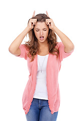 Image showing Woman, playful and devil horns in studio, bully and naughty gesture for attitude on white background. Female person, bad girl and fingers for emoji, bull and comedy or humor on isolated backdrop