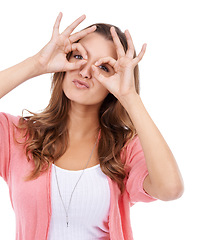 Image showing Hand glasses, portrait and woman in studio with funny, silly or goofy personality on white background. Eyes, frame and face of female model with finger shape for nerd, gesture or crazy, playful mood