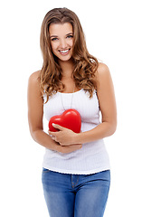 Image showing Woman, portrait and heart for love in studio, smiling and confidence with emoji on white background. Female person, happy and symbol for romance on valentines day, support and peace or kindness