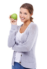 Image showing Woman, portrait and apple for nutrition in studio, organic fiber and fruit for wellness. Female person, vitamins and minerals for healthy living, snack and vegan food on white background for diet