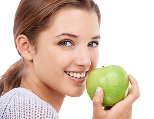 Image showing Woman, portrait and eating apple, nutrition and gut health with snack or meal, diet for weight loss on white background. Healthy food, wellness and fruit, vegan and organic with smile in studio