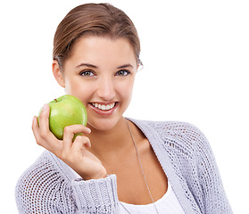 Image showing Woman, portrait and apple, nutrition and gut health with snack, happy with diet for weight loss on white background. Healthy food, wellness and green fruit, vegan and organic with smile in studio