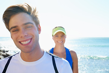 Image showing Happy couple, runners and portrait in beach, workout and fitness with smile, training and outdoor for run. Man, woman and athletic in ocean, sea and exercise together in summer, morning and young