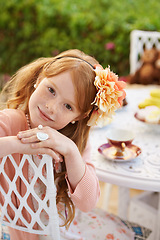 Image showing Girl, child and tea party with happiness in garden with portrait for birthday, celebration and playing outdoor. Person, kid and face in backyard of house with dress up, beverage and role play fun