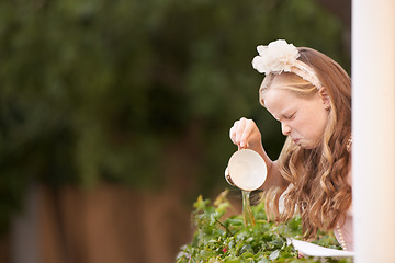 Image showing Child, tea and pouring or disgust in garden for gross taste at party event or unhappy, drink or disappointed. Female person, girl and cup or warm beverage fail for strong flavour, outdoor or backyard