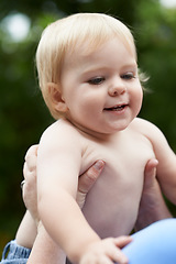 Image showing Baby, person and playing outdoor for development with nurture, relationship and bonding for happiness. Family, child or toddler and hands with early childhood, parenting and love at park in nature