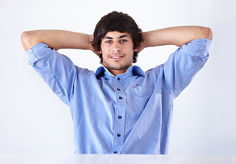 Image showing Happy man, portrait and relax at office on break for done, completion or finished on a white studio background. Face of young handsome male person or employee in rest with blue clothing or fashion