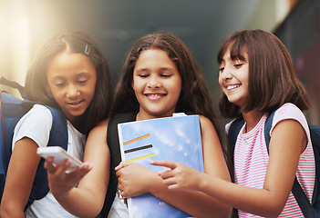 Image showing Elementary school, group of friends or girls with phone, reading social media notification or download digital app. Diversity, students or happy kids pointing to mobile, tech or typing online for fun