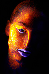 Image showing Portrait, fantasy and creative with neon woman on black background for makeup, glitter or colorful glow. Face, art and beauty with confident young person in the dark for psychedelic or techno paint