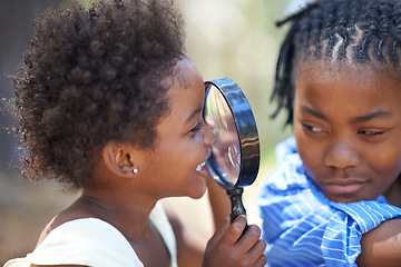 Image showing Kids, nature and magnifying glass in a forest for face, inspection or discovery in search together. Black family, children and magnifier in park for adventure, learning or exploring, games or fun