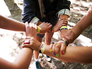 Image showing People, hands together and outdoor festival with arm bands for community, teamwork or unity at event. Group of friends piling or circle for synergy, motivation or party at music carnival outside