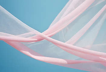 Image showing Flying pink transparent fabric wave on blue background and illum