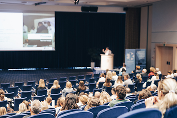 Image showing Speaker giving a talk on scientific conference. Audience at the conference hall. Business and Entrepreneurship concept.