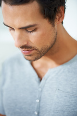 Image showing Face, thinking and regret with a young man closeup on a white background for error, mistake or fail. Depression, sad or worry and a concerned young person looking down with stress or anxiety