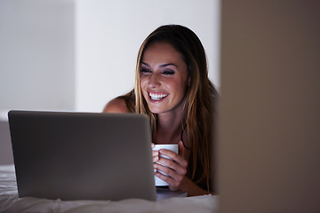 Image showing Happy woman, laptop and coffee on bed in morning for online entertainment or streaming at home. Young female person smile with beverage, latte or tea in relax on computer for social media in bedroom