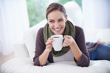 Image showing Coffee, thinking and happy woman relax on a sofa with memory, moment or reflection in her home. Tea, break and female person in a living room with comfort, beverage or day off, me time or self care