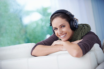 Image showing Woman, portrait and music headphones on sofa at home for audio subscription, streaming multimedia and song in lounge. Happy lady, relax and listening to podcast, hearing sound and radio entertainment