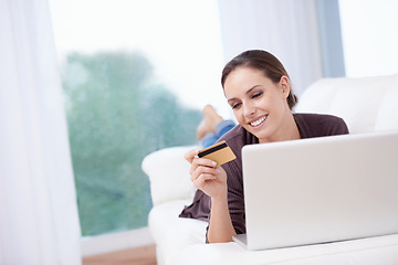Image showing Happy, woman and credit card with laptop on sofa to pay for online shopping, sales and ecommerce. Internet, banking and person in home with computer and virtual payment of service or product