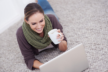 Image showing Home, laptop and woman on the floor, smile and typing with coffee and connection in a lounge. Person, apartment or girl with computer, espresso and research for a project, freelancer or copywriting