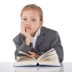 Image showing Bored, child and reading book in studio portrait, learning and fiction novel on white background. Female person, fatigue and information for education, exhausted and tired for studying literacy