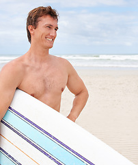 Image showing Thinking, smile and body of man with surfboard at beach on blue sky for sports, travel or fitness. Nature, vision and happy young shirtless surfer on sand by ocean or sea for exercise and training