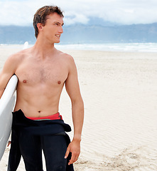 Image showing Thinking, space and shirtless man with surfboard on beach in wetsuit for travel, exercise or fitness. Nature, summer and body of young surfer on blue sky by ocean or sea with sand for sports training