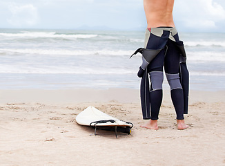 Image showing Beach, body or ready to start surfing with surfboard on vacation or adventure for fitness or travel. Back view of athlete, swimwear or man at seaside on holiday in Hawaii or ocean in extreme sports