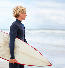 Image showing Surfer, man and sea view on beach with surfboard, vacation and adventure for fitness and travel. Ocean, waves for surfing and seaside holiday in Hawaii, nature and tourism with extreme sports