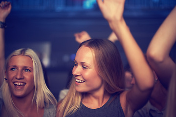 Image showing Nightclub, women and happy at party with dancing for performance, entertainment and hands raised. Music festival, people and friends with disco, concert or audience on dance floor at social event