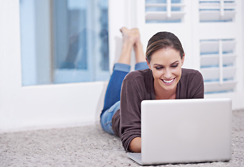 Image showing Woman, remote work and laptop to relax on floor, update blog post and digital news on social media at home. Happy freelancer, computer or download subscription, online shopping or streaming on ground