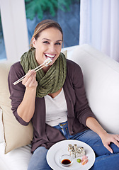 Image showing Woman, eating sushi and food in living room, portrait with lunch or dinner, Japanese cuisine and seafood with chopsticks. Catering, hungry and diet, relax with meal at home and dish for nutrition