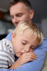 Image showing Father, son and sleeping with hug in home with bonding, trust and support in living room of house. Family, man and parent or boy child with rest, dreaming and tired or relax in lounge of apartment