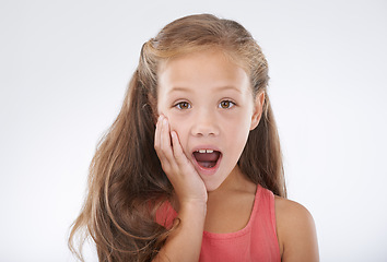 Image showing Child, portrait and hand for surprise news in studio for announcement, information or review. Female person, face and shocked on white background for giveaway secret as wow mockup, winner or drama