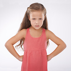 Image showing Child, portrait and unhappy grumpy in studio or bad mood discipline or development, trouble or angry. Female person, hands and hips in frustration for girl kid as white background, attitude or mockup