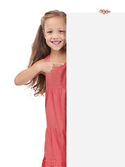 Image showing Child, portrait and placard board or pointing in studio for announcement, information or white background. Female person, mockup space or news poster or bulletin review opinion, billboard or message