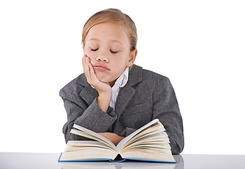 Image showing Sleeping, child and reading book in studio, learning and fiction novel on white background. Female person, fatigue and info for education, exhausted and tired for studying literacy and knowledge