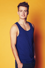 Image showing Fashion, smile and portrait of man in studio with trendy, cool or summer clothes on orange background. Face, style and male model with confidence, personality or casual, streetwear or outfit choice