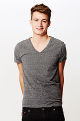 Image showing Portrait, smile and man with fashion, casual outfit and confident guy on a white studio background. Person, happy and model with t shirt, cool and stylish clothes with student, aesthetic and joyful
