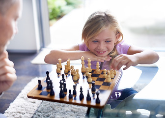 Image showing Smile, kid and father play chess in home, family bonding together or development. Happy girl, man and board game of strategy, challenge or entertainment of young child in competition match in house